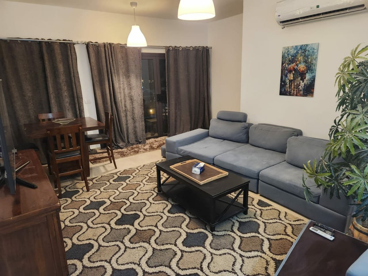 Fifth Square apartment 514-05 Living room with grey sofa and wooden dining table - apartment in Golden Square, Fifth Square, New Cairo