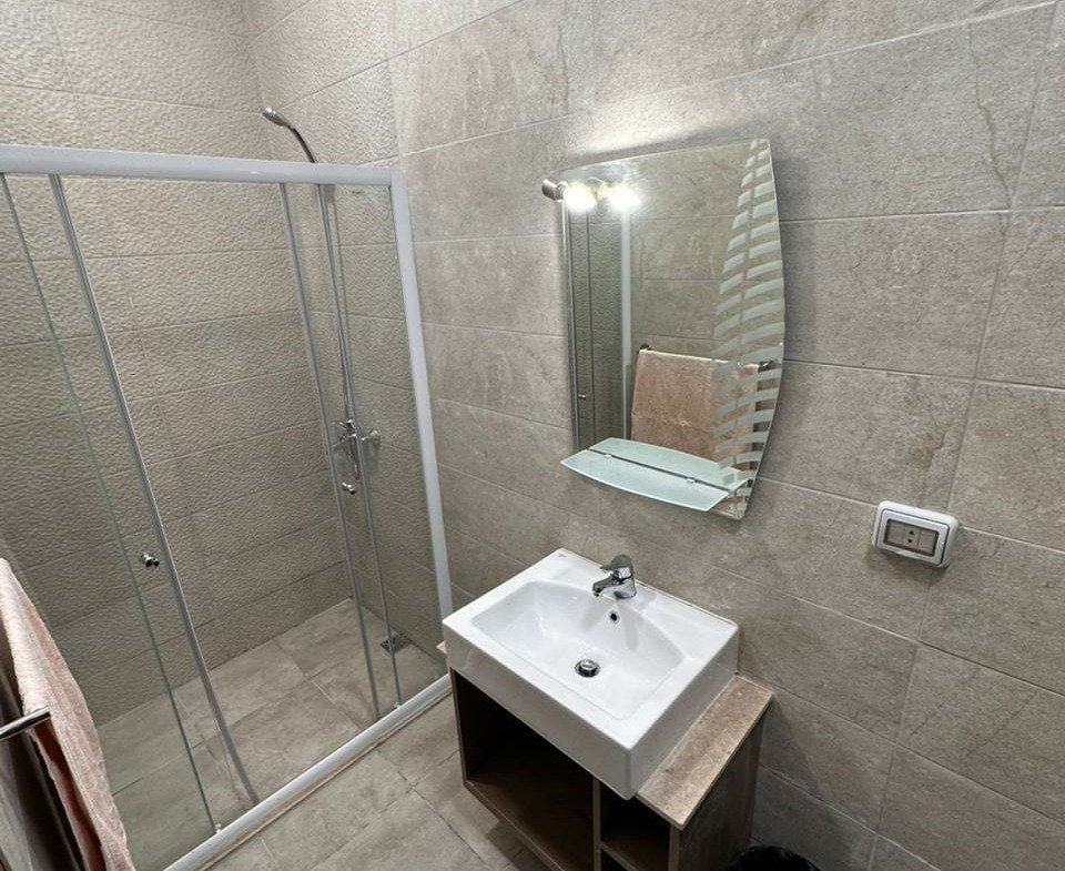 Bathroom with glass shower and washbasin - apartment in Golden Square, Fifth Square, New Cairo