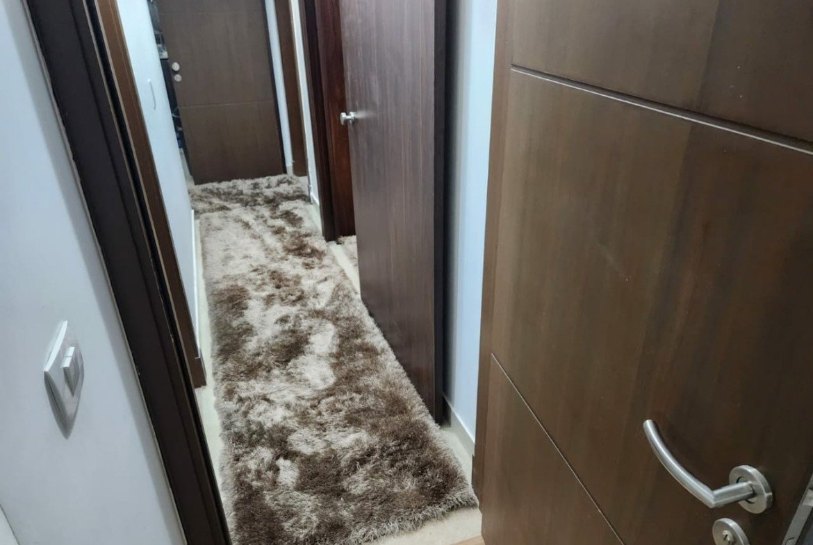 Hallway with wooden doors and rug - apartment in Golden Square, Fifth Square, New Cairo