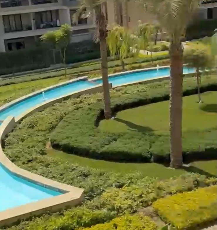 Water channel and gardens seen from above - apartment in Fifth Square, New Cairo