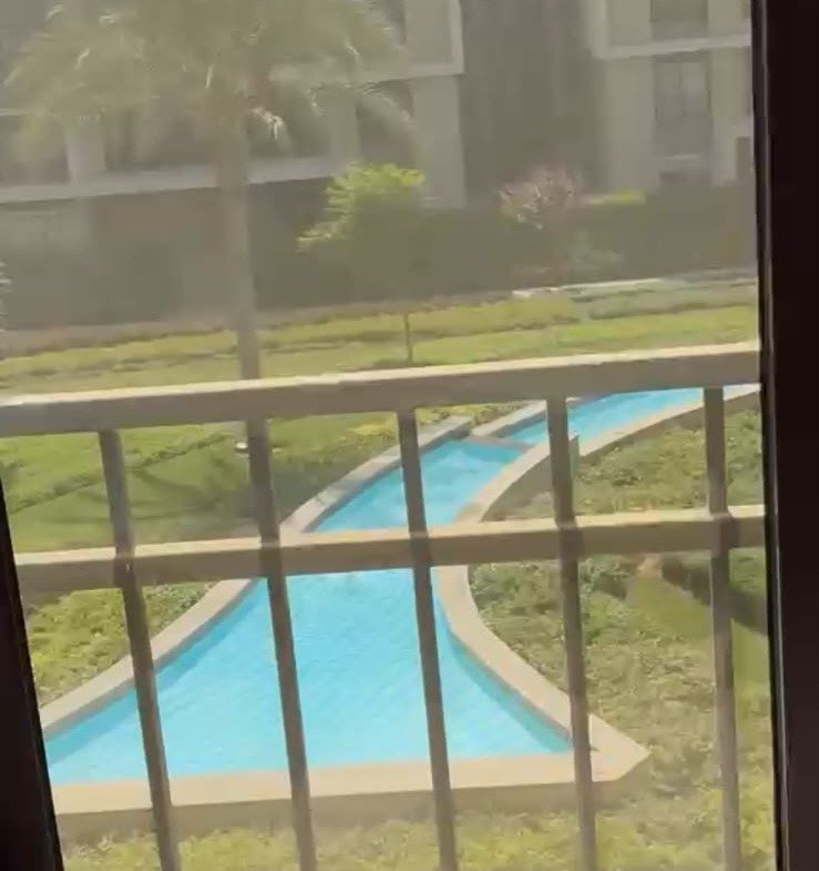 Pool seen through the balcony railing - apartment in Fifth Square, New Cairo