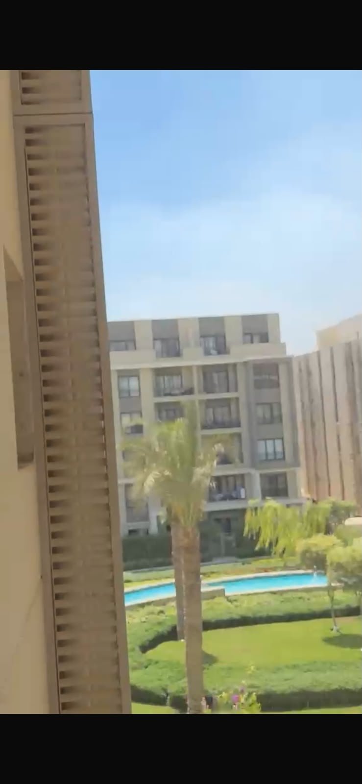 5th-square-apartment-for-rent-461-09 Pool and buildings seen from the balcony - apartment in Fifth Square, New Cairo