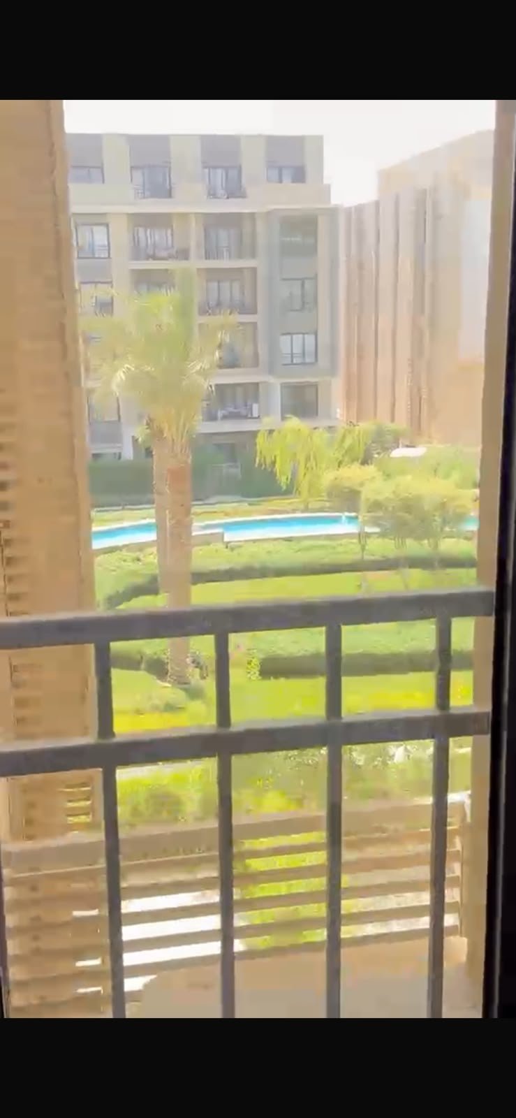 5th-square-apartment-for-rent-461-10 Balcony railing and garden view - apartment in Fifth Square, New Cairo
