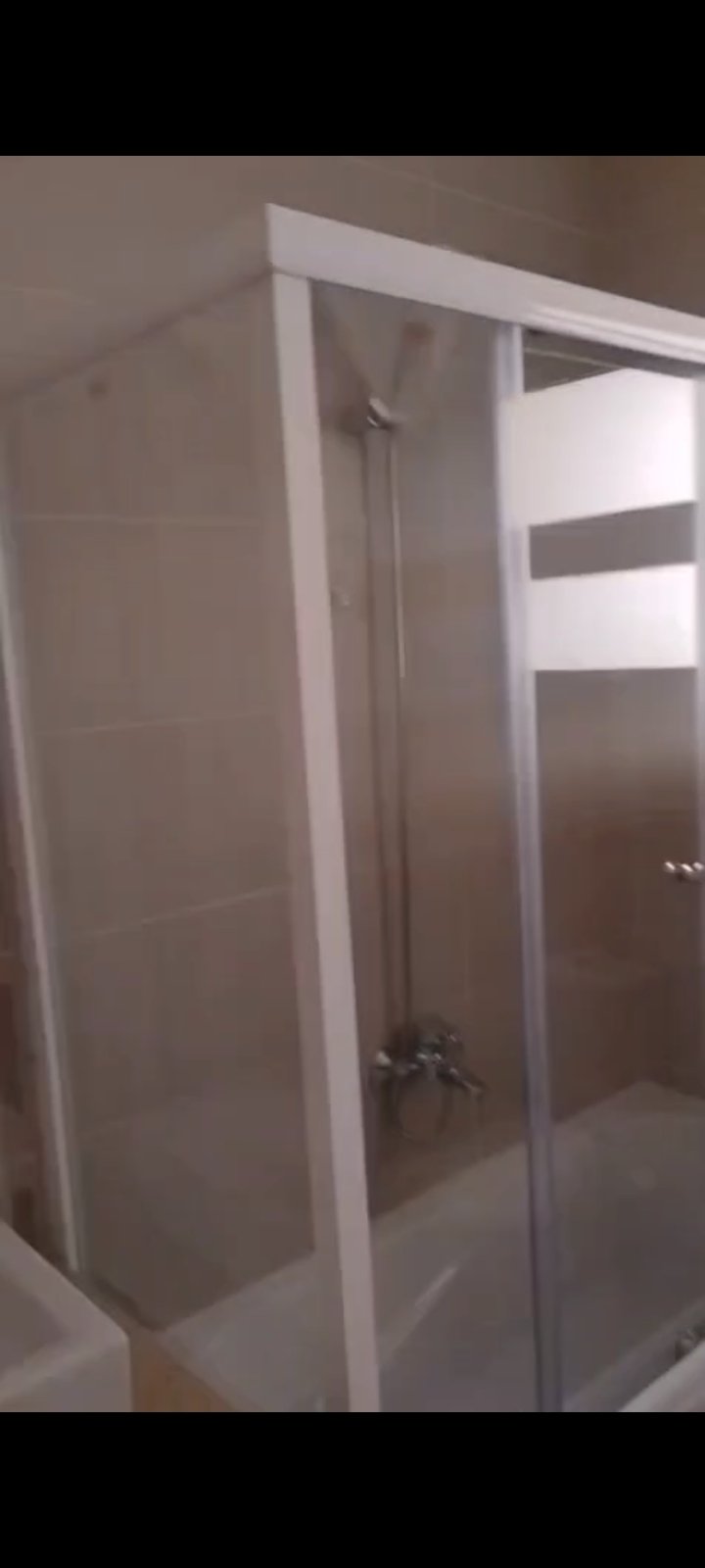 Shower cabin in an empty bathroom - apartment in Fifth Square, New Cairo