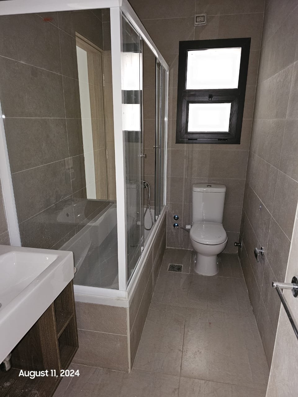 Bathroom with glass shower and toilet - studio in Fifth Square, New Cairo