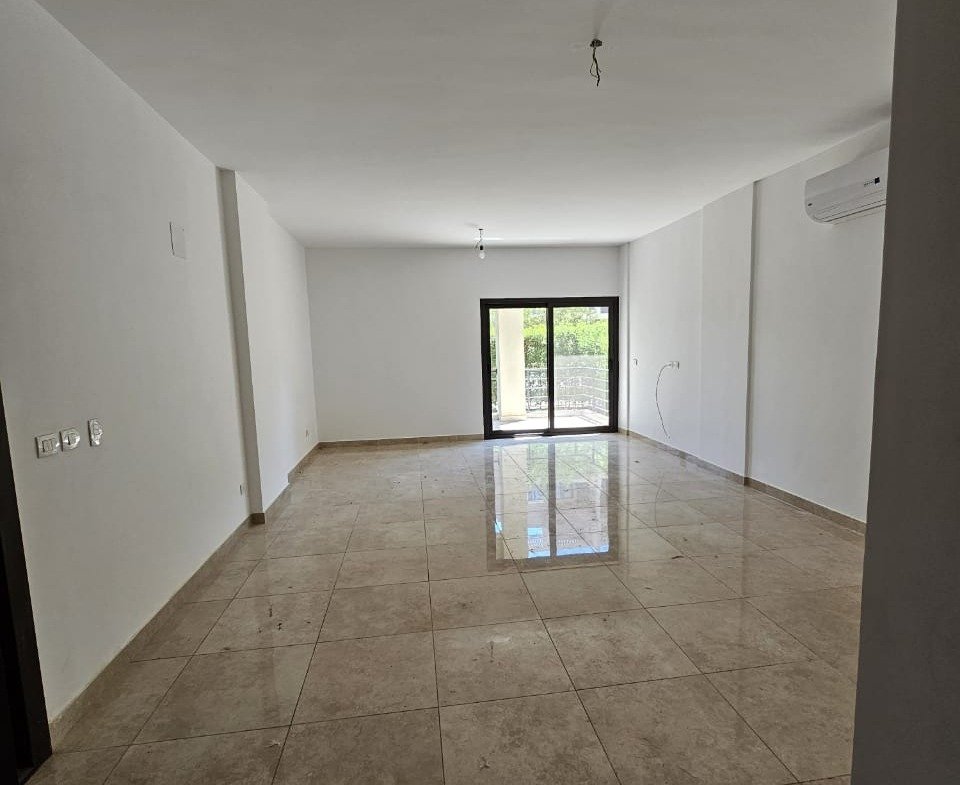 Empty living room with glossy floor - studio in Fifth Square, New Cairo