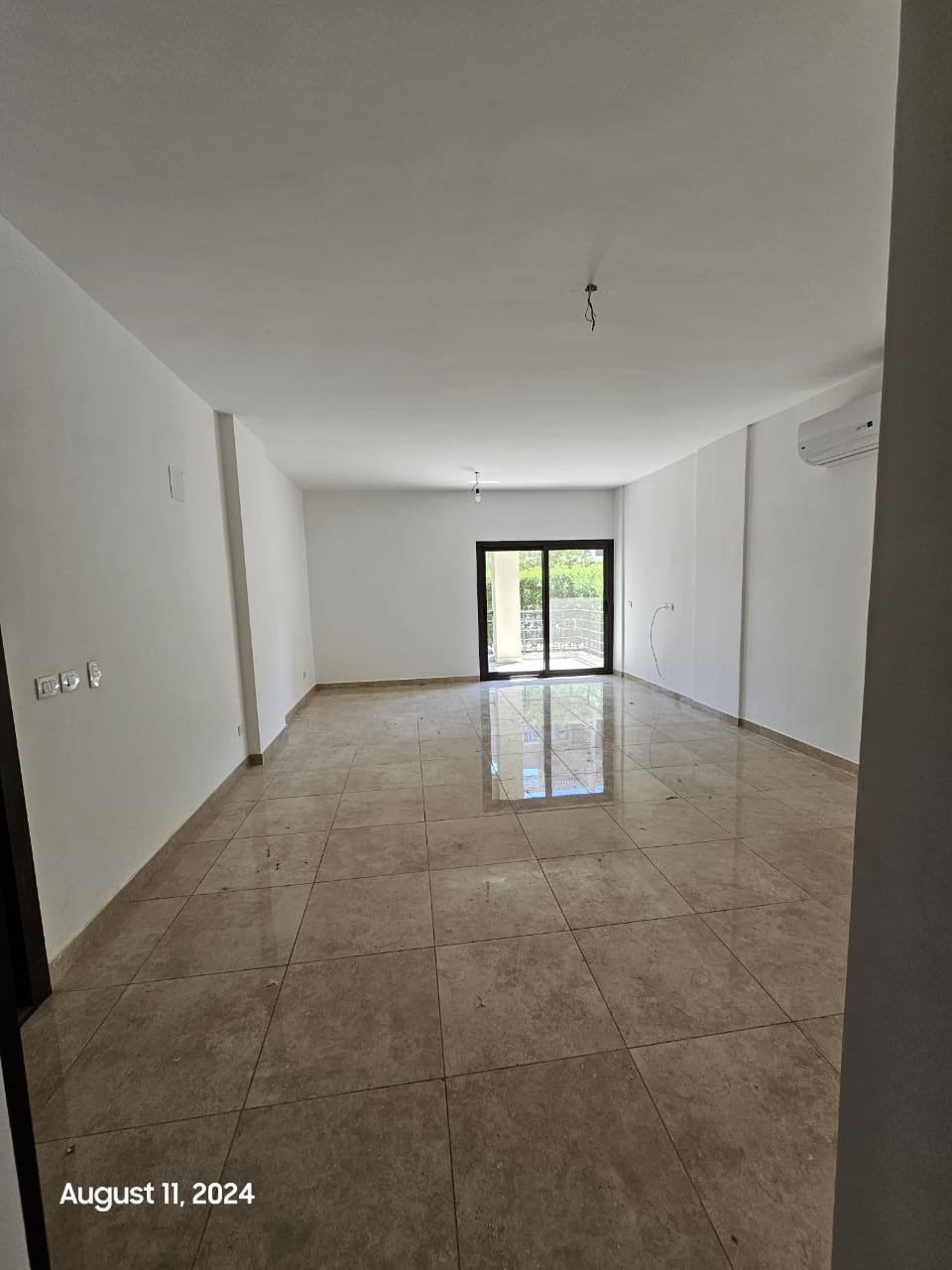 Empty living room with glossy floor - studio in Fifth Square, New Cairo