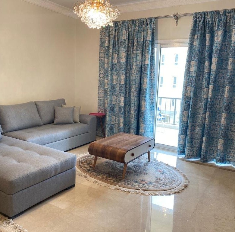 Furnished reception with balcony doors, Mivida Boulevard furnished apartment for rent | ريسيبشن مفروش بأبواب بلكونة، شقة مفروشة للإيجار في ميفيدا بوليفارد
