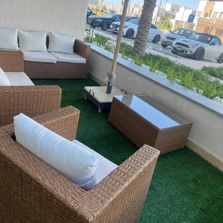Covered furnished terrace with outdoor view, chalet for rent in Marassi Faya, North Coast | تراس مغطى مفروش بإطلالة خارجية، شاليه للإيجار في مراسي فايا، الساحل الشمالي