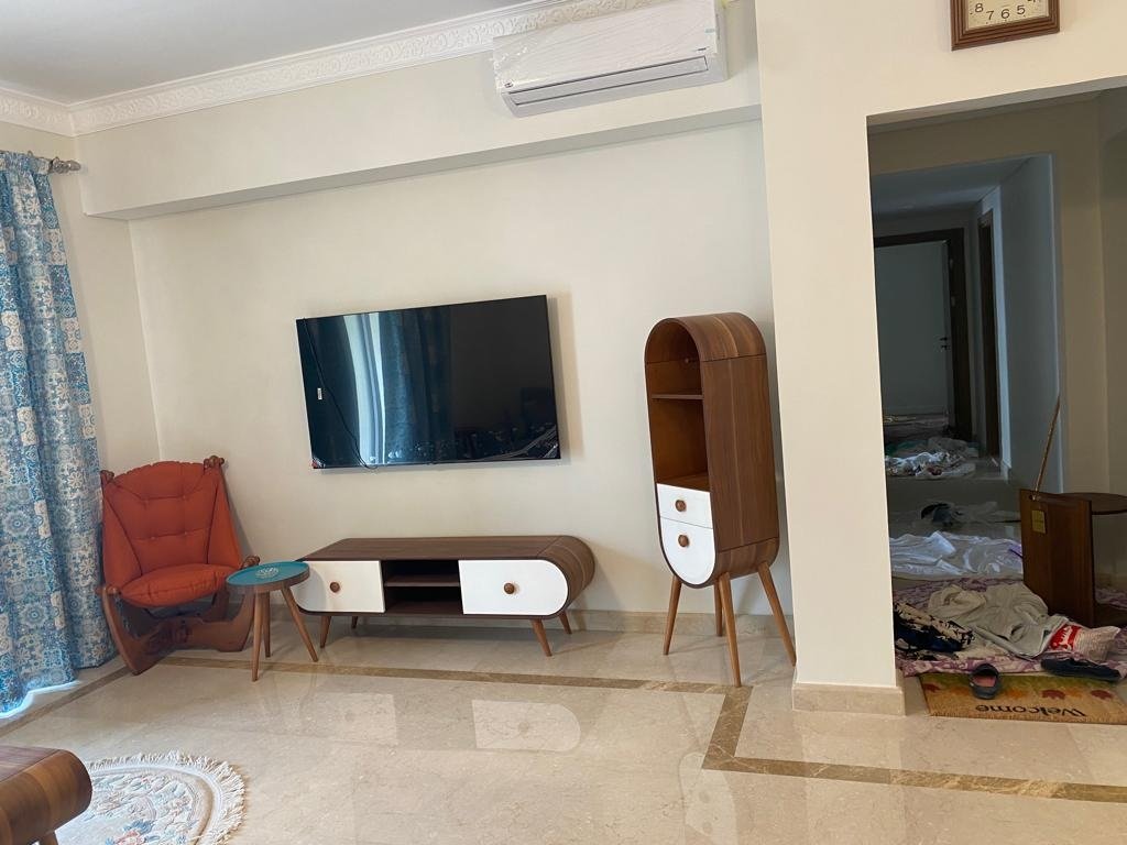 Living area with television, Mivida Boulevard furnished apartment for rent | منطقة معيشة بتلفزيون، شقة مفروشة للإيجار في ميفيدا بوليفارد
