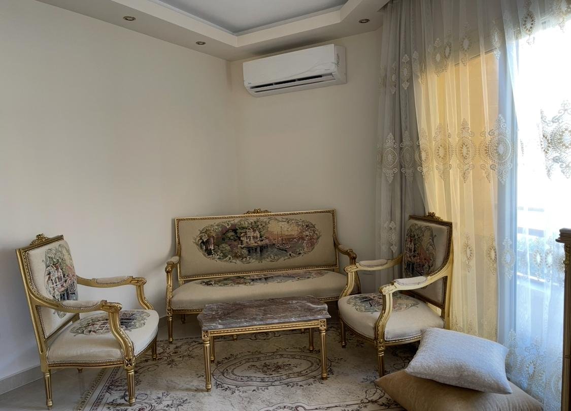 akoya-513-10 Classic gilded sofa set by a sunlit window - apartment in Akoya, New Cairo