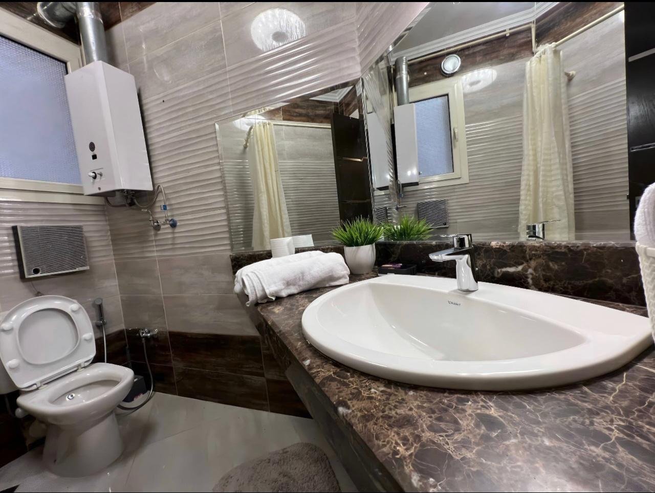 akoya-513-15 Bathroom with a round basin and a marble counter - apartment in Akoya, New Cairo