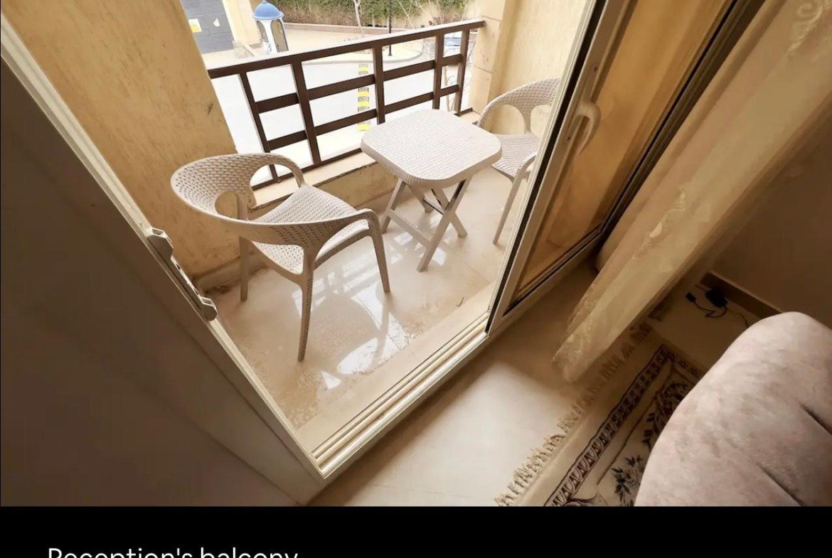 Small balcony with two chairs and a table - apartment in Akoya, New Cairo