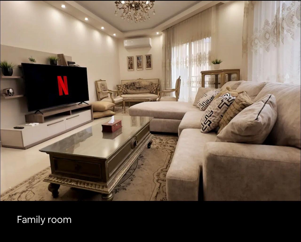 akoya-513-18 Family living room with a TV unit and a beige sofa - apartment in Akoya, New Cairo