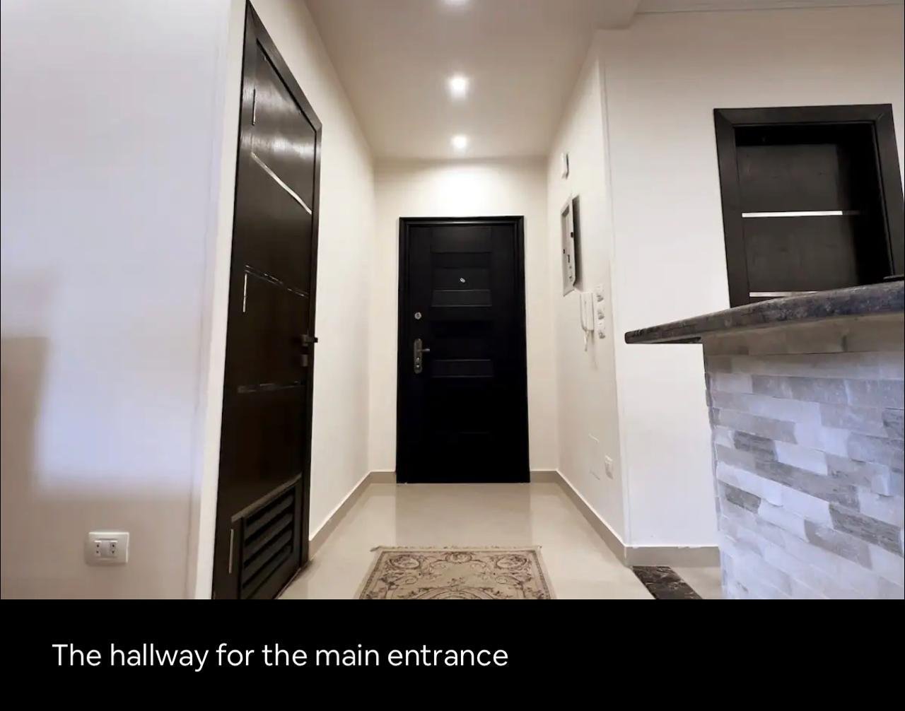 akoya-513-19 Entrance hallway with a dark front door - apartment in Akoya, New Cairo