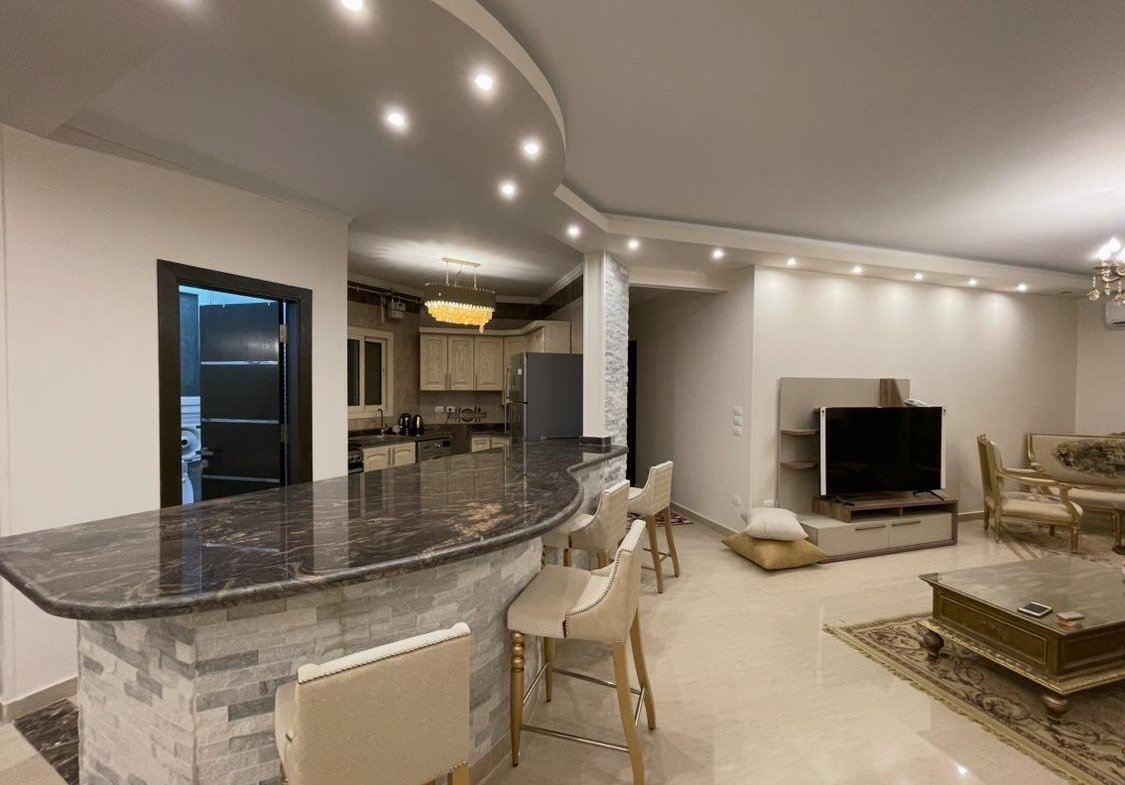 Kitchen bar looking toward the TV and living area - apartment in Akoya, New Cairo