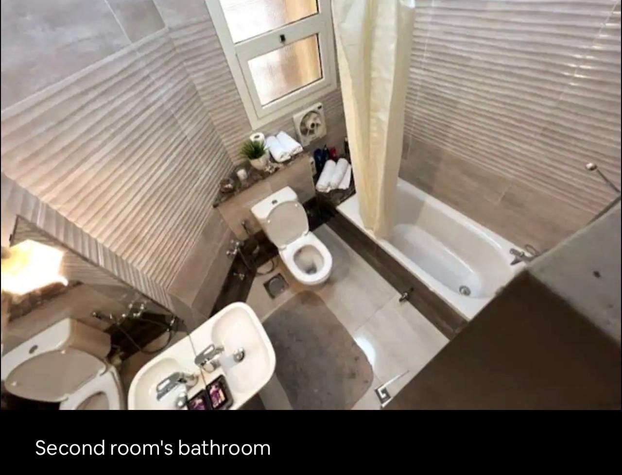 akoya-513-20 Bathroom with a bathtub and a wall-mounted basin - apartment in Akoya, New Cairo