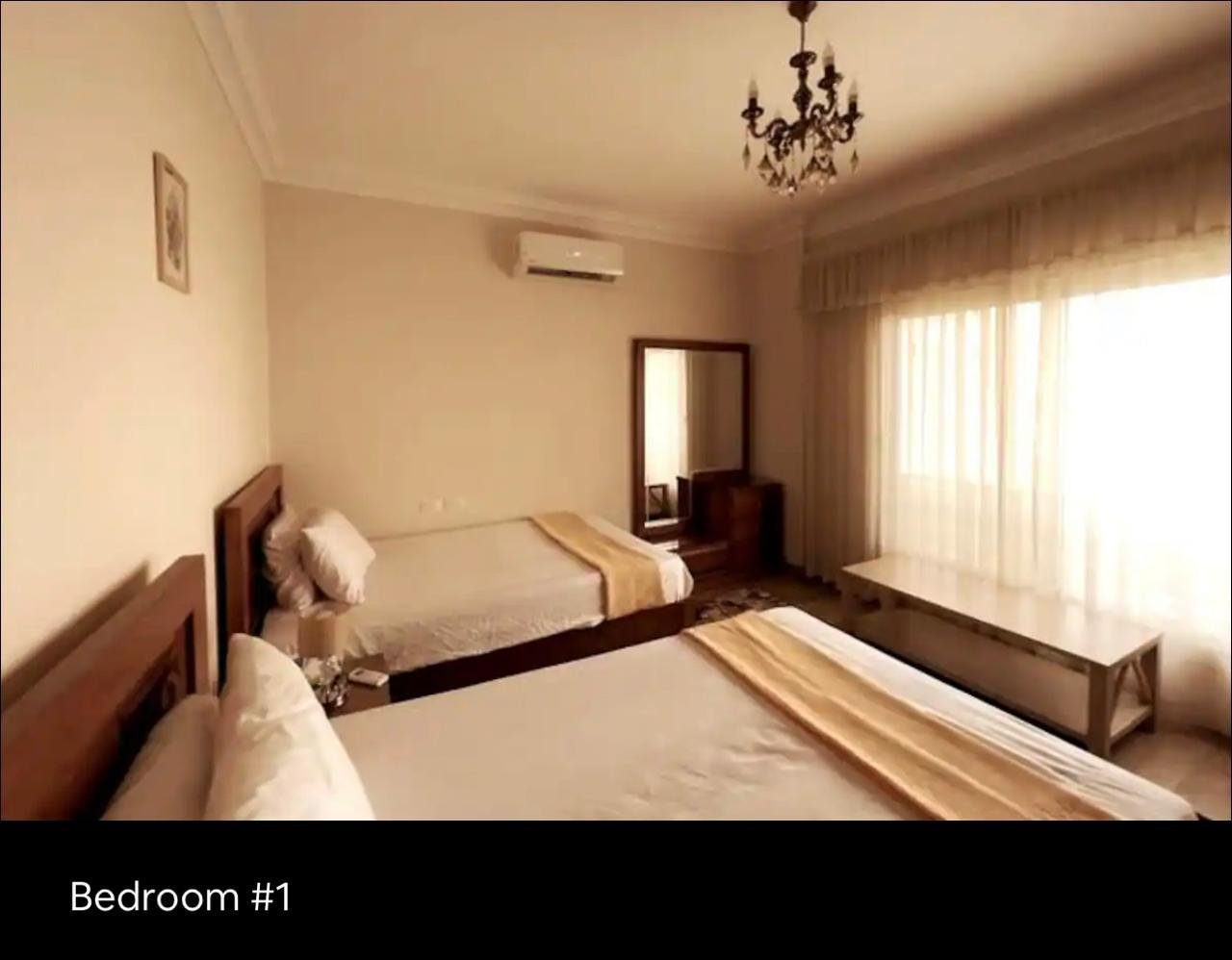 akoya-513-23 Bedroom with a striped bed runner and sheer curtains - apartment in Akoya, New Cairo