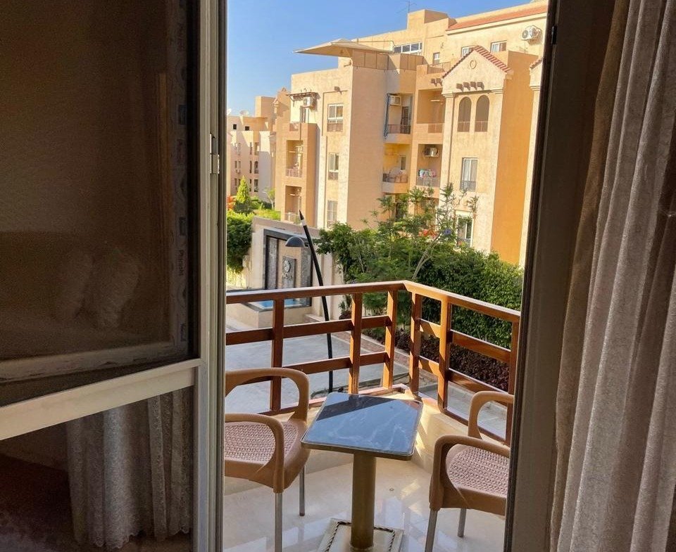 Balcony door opening onto a view of the buildings - apartment in Akoya, New Cairo