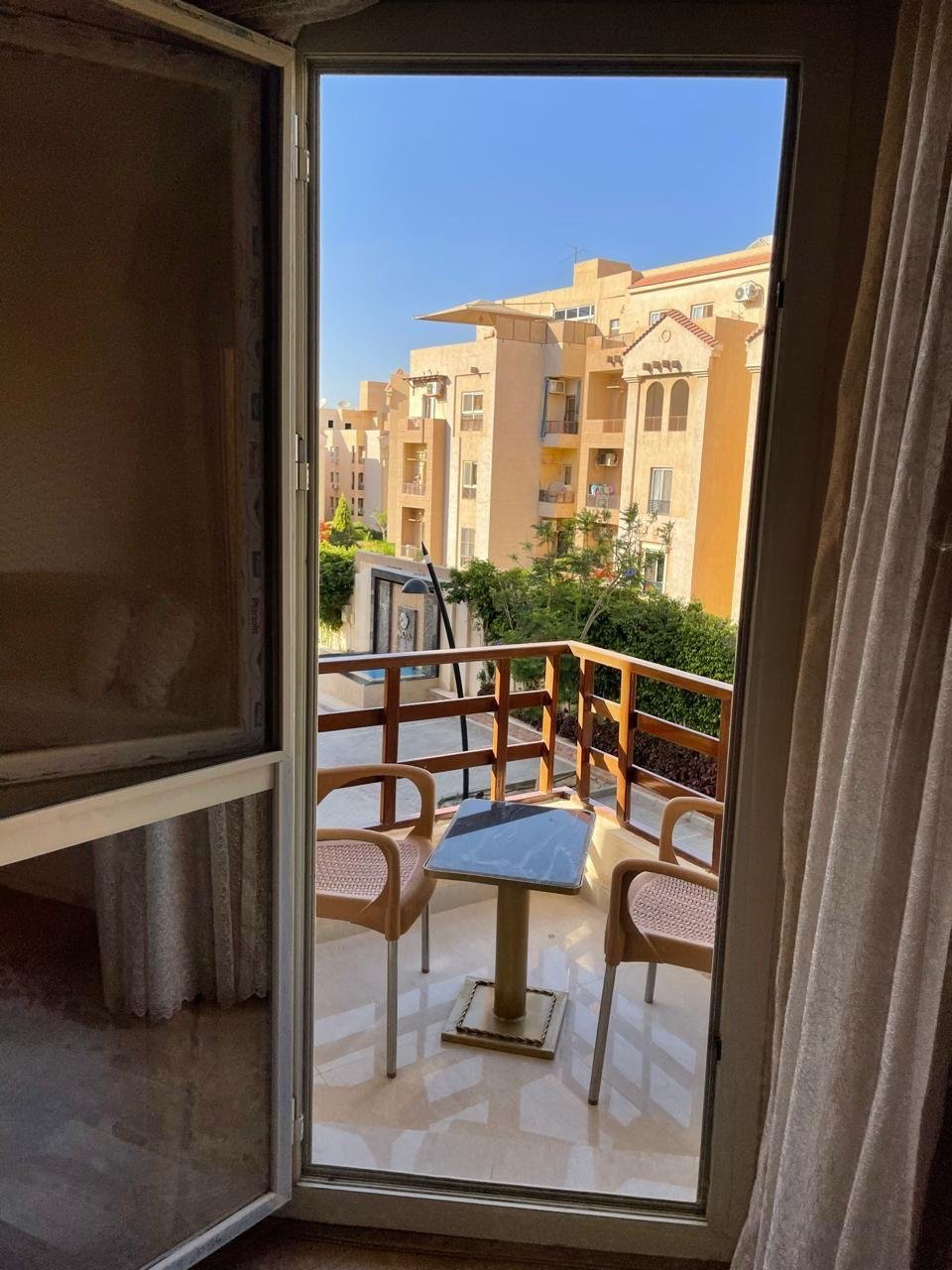 akoya-513-24 Balcony door opening onto a view of the buildings - apartment in Akoya, New Cairo