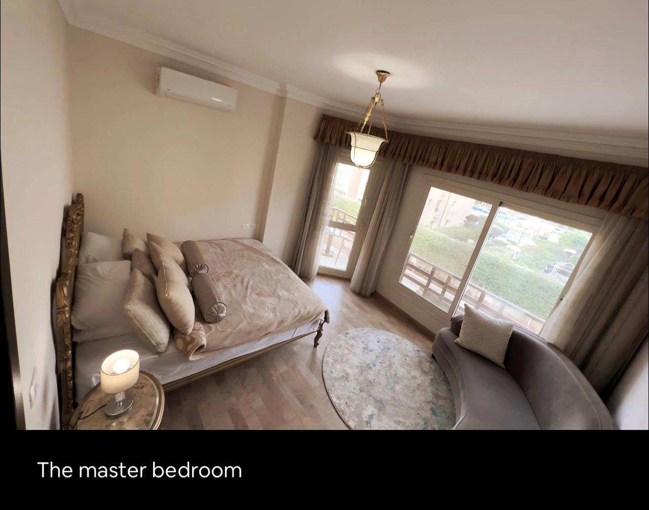 akoya-513-29 Bedroom with a double bed and a sitting area by the window - apartment in Akoya, New Cairo