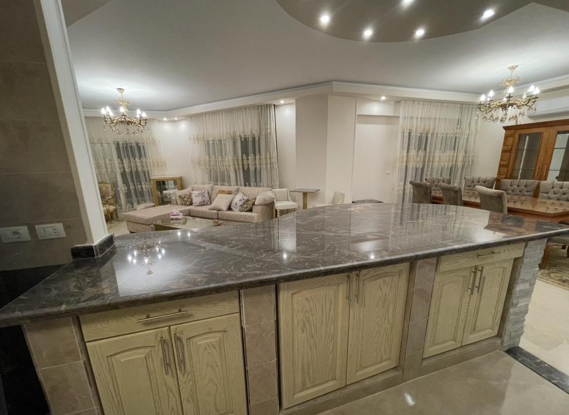 akoya-513-5 Kitchen island with cream cabinet doors facing the reception - apartment in Akoya, New Cairo