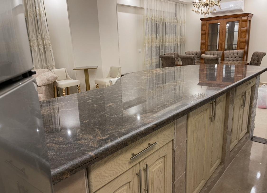 akoya-513-7 Granite kitchen counter with cream wooden cabinets - apartment in Akoya, New Cairo