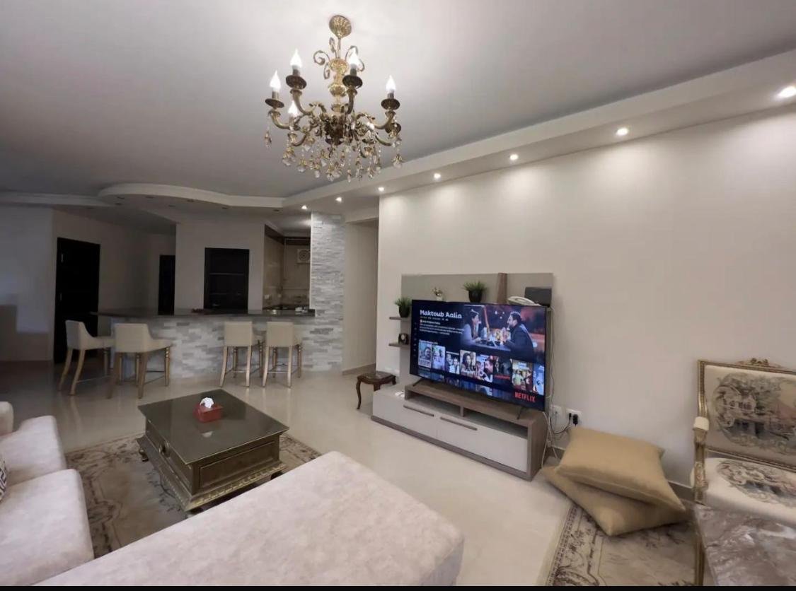 akoya-513-9 Reception with a wall-mounted TV and a coffee table - apartment in Akoya, New Cairo
