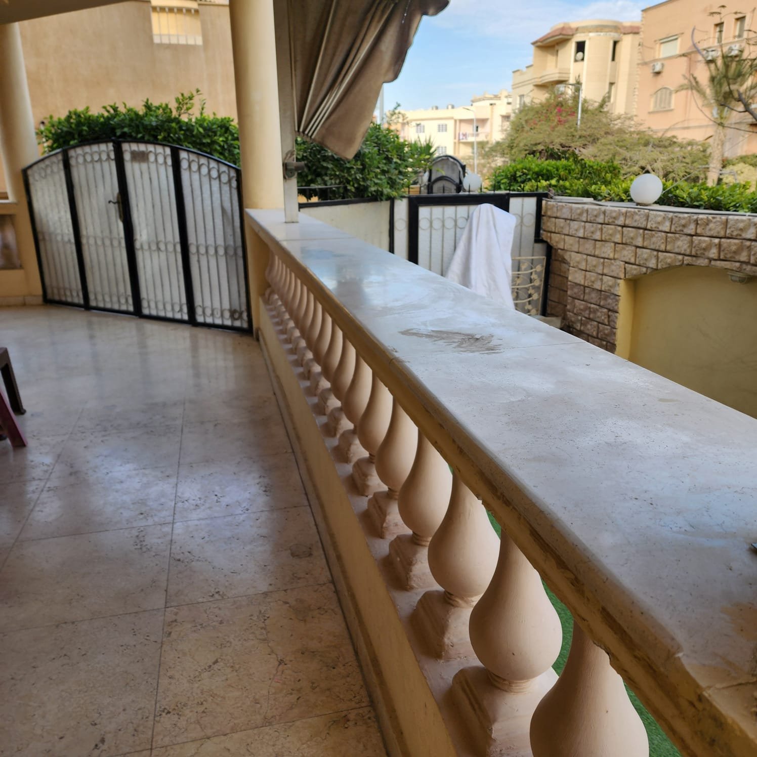 Window with a view of nearby houses and a grey wall - apartment in Al Narges, New Cairo