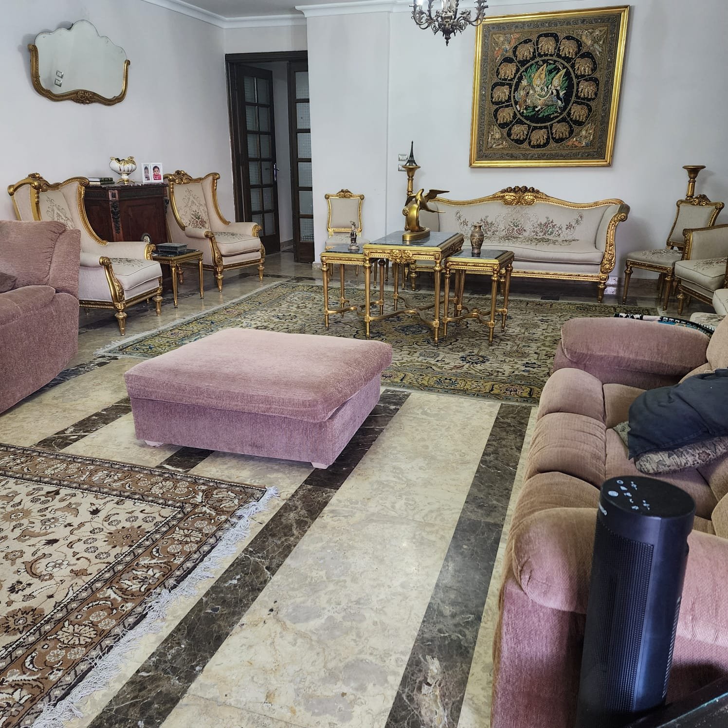 Reception with pink velvet sofas and a patterned marble floor - apartment in Al Narges, New Cairo