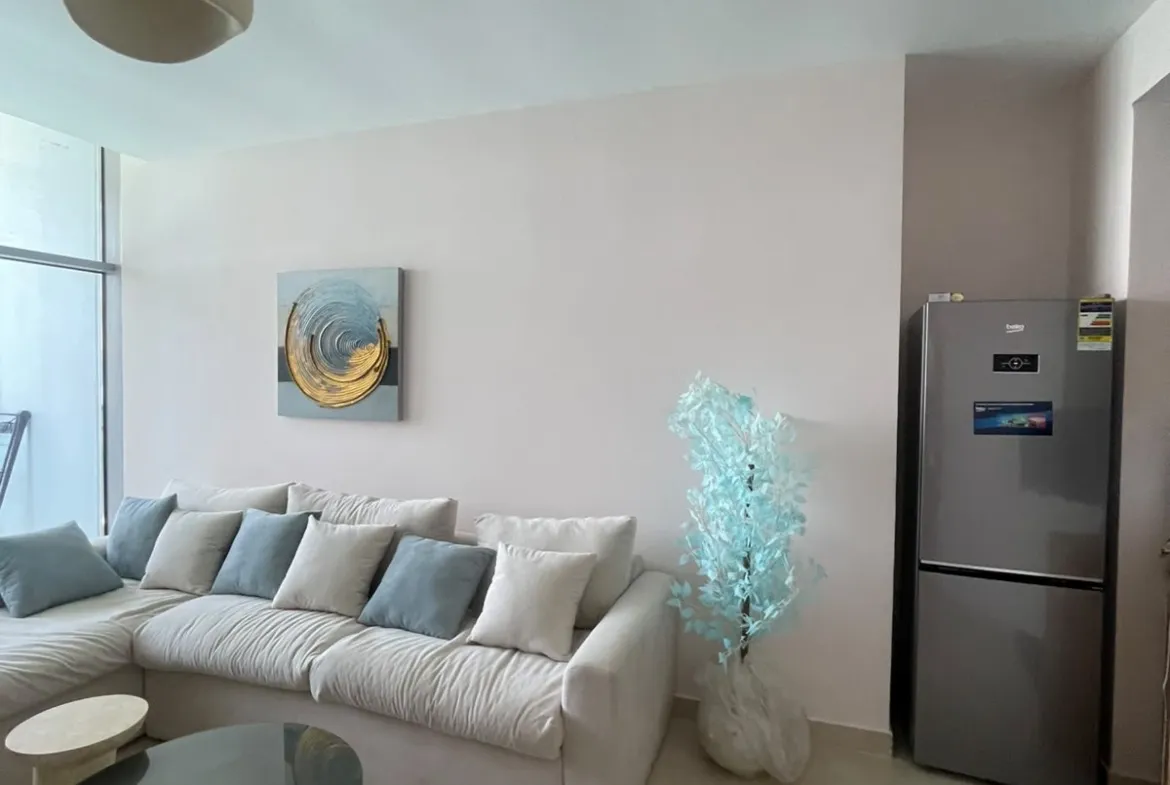 Living room with a beige sofa and a patterned rug - chalet in North Edge Towers, New Alamein