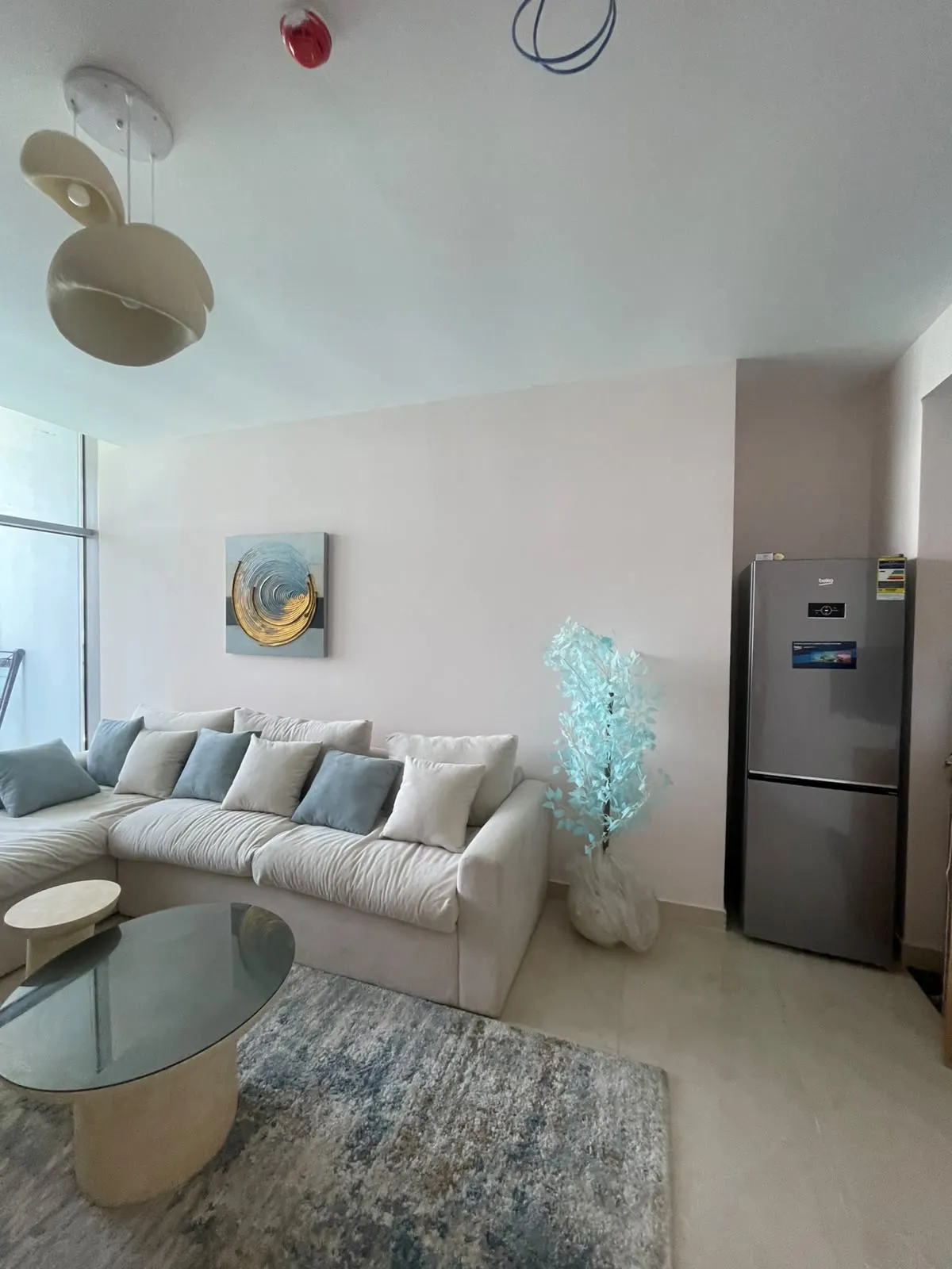Living room with a beige sofa and a patterned rug - chalet in North Edge Towers, New Alamein