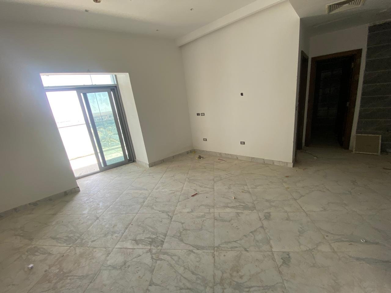 Unfurnished room with marble flooring and a balcony door - chalet in Alamein Towers