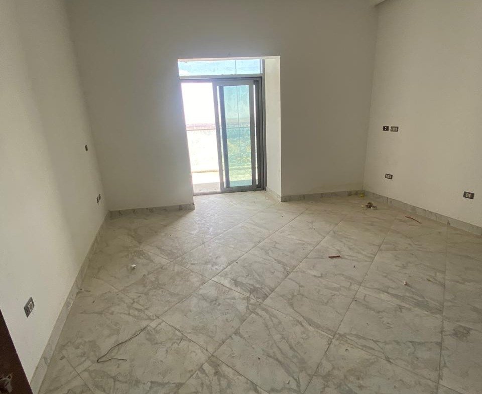 Empty room with a single window and marble floor - chalet in Alamein Towers