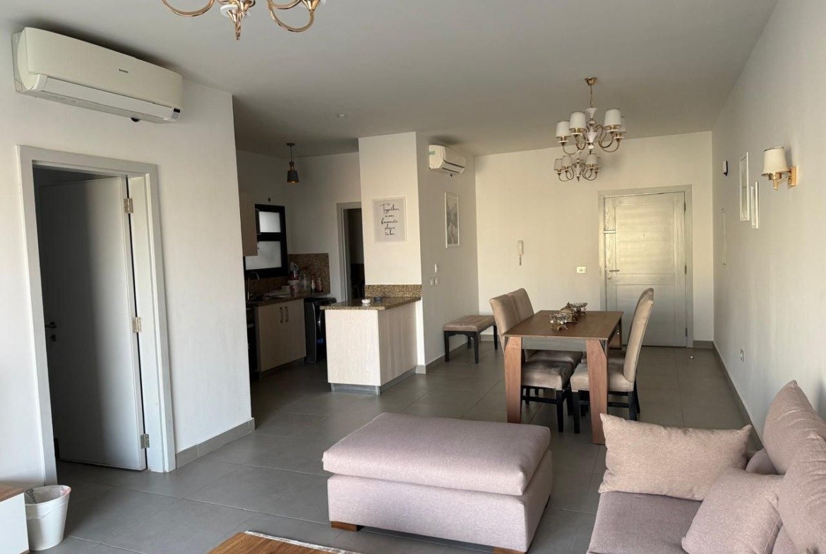 Open living and dining area with grey furniture - apartment in Alburouj, Shorouk City