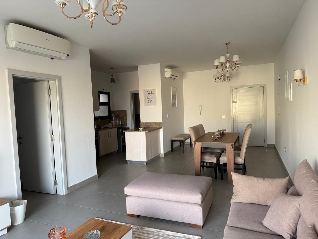 Open living and dining area with grey furniture - apartment in Alburouj, Shorouk City