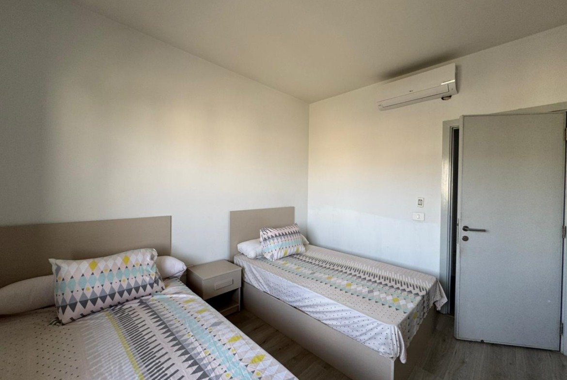 Bedroom with two single beds and a dresser - apartment in Alburouj, Shorouk City