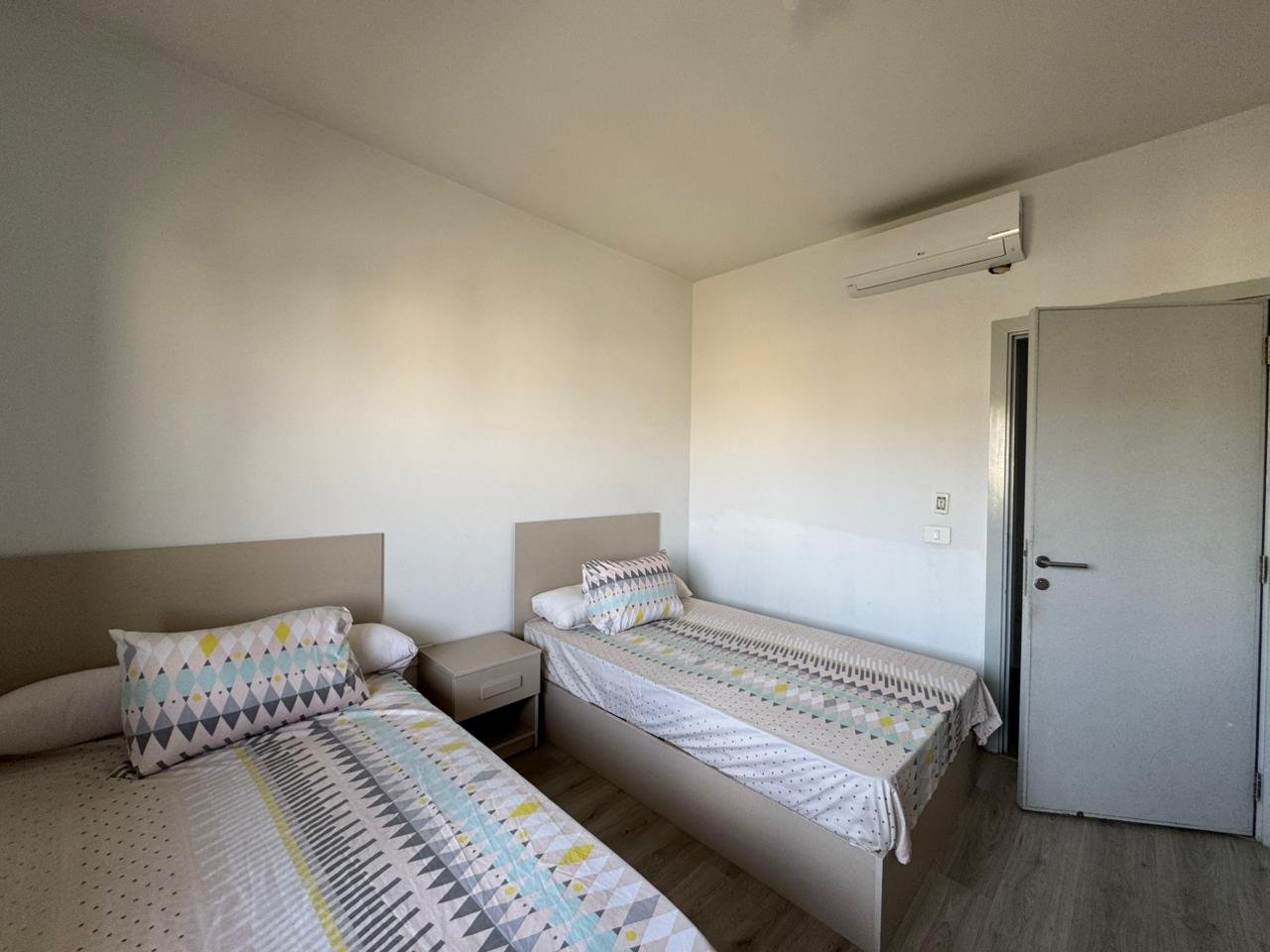 Bedroom with two single beds and a dresser - apartment in Alburouj, Shorouk City