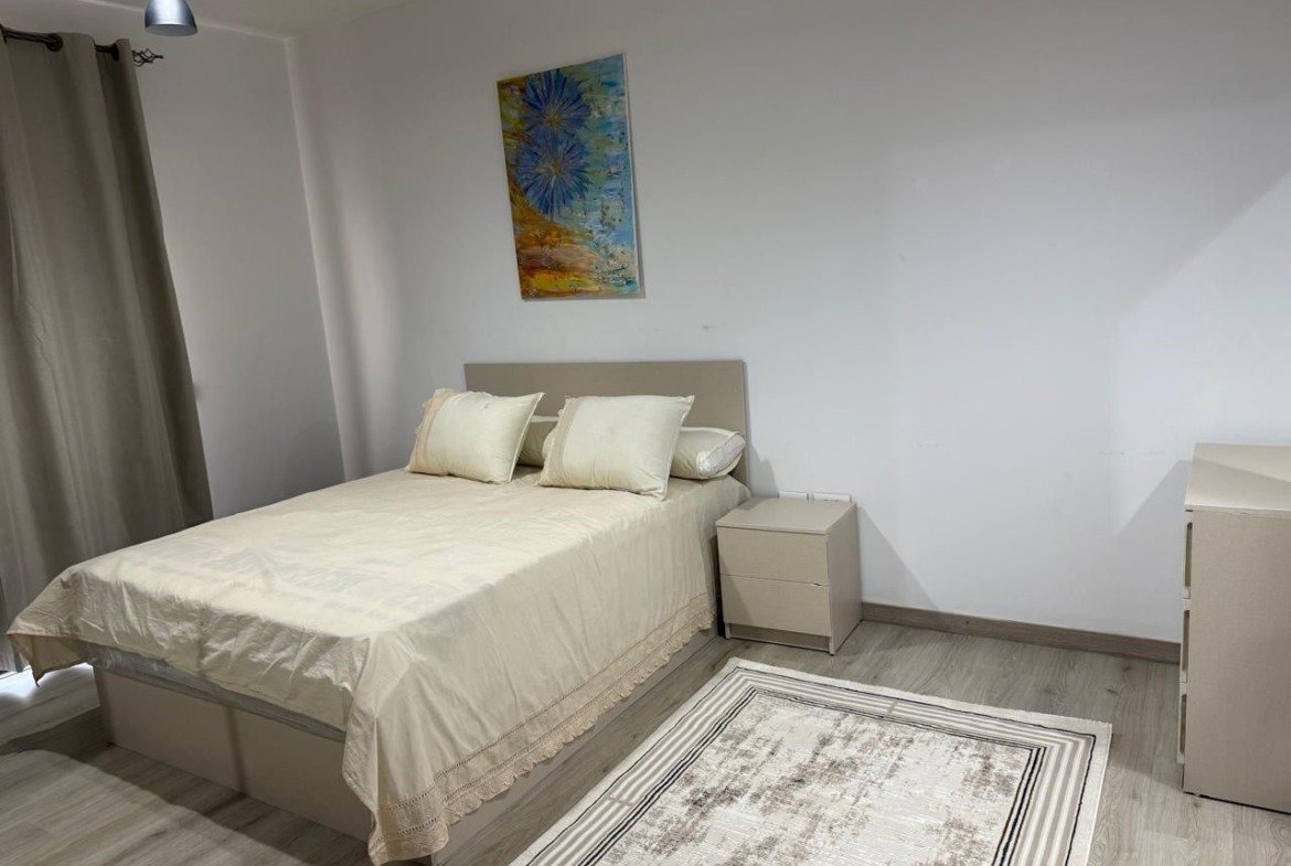Bedroom with white bedding and a patterned rug - apartment in Alburouj, Shorouk City