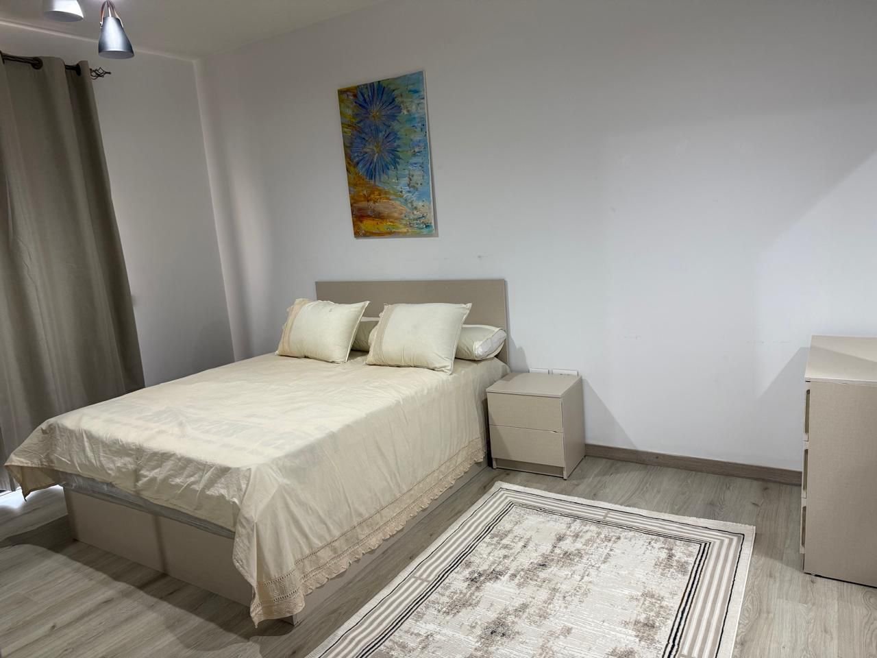 Bedroom with white bedding and a patterned rug - apartment in Alburouj, Shorouk City