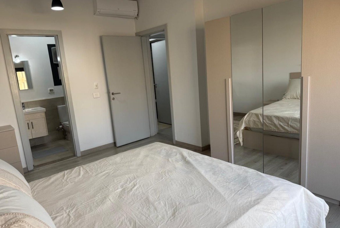 Bedroom with a fitted wardrobe and en-suite bathroom - apartment in Alburouj, Shorouk City