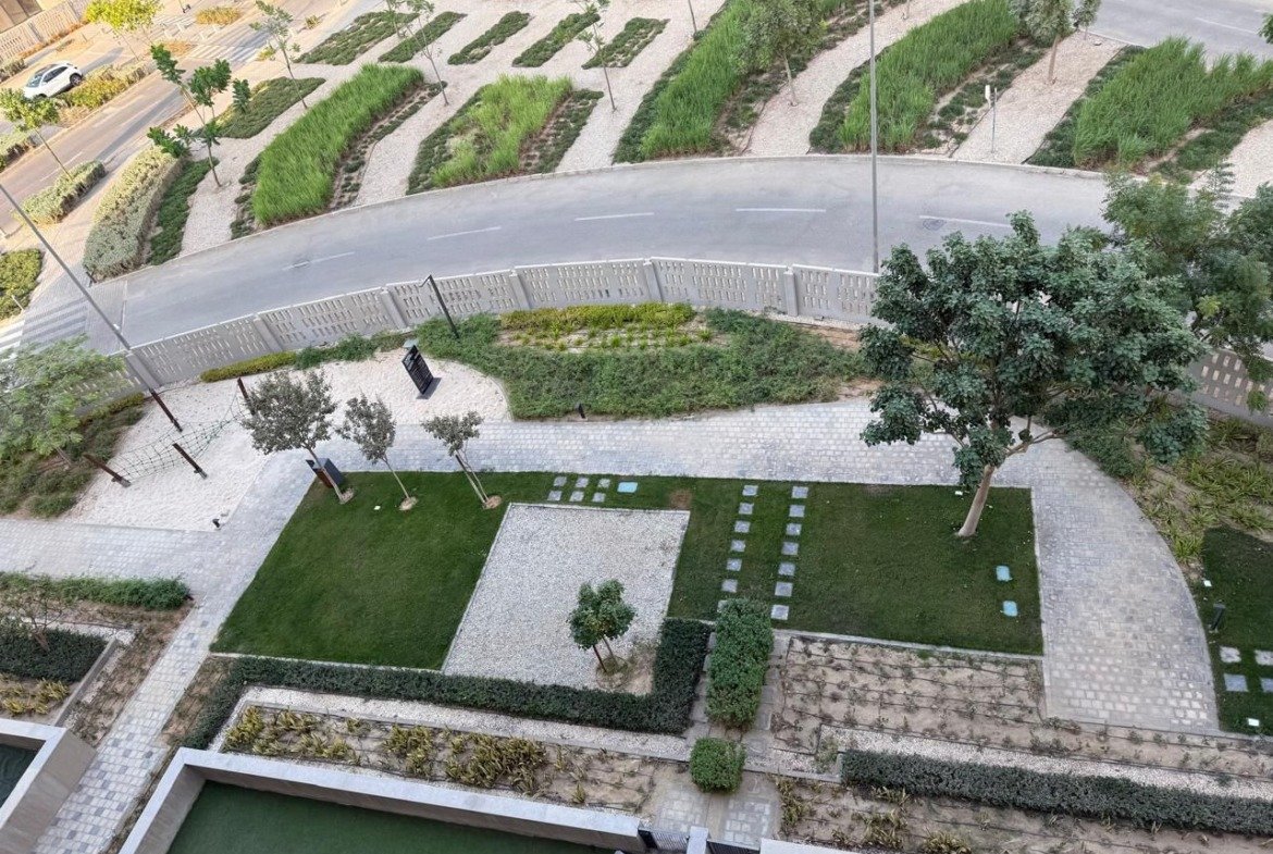 Aerial view of landscaped gardens and a pool - apartment in Alburouj, Shorouk City