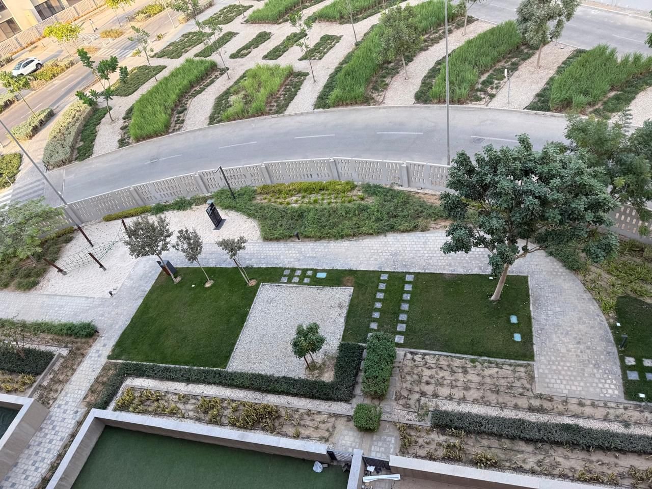 Aerial view of landscaped gardens and a pool - apartment in Alburouj, Shorouk City