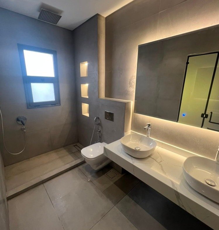 Bathroom with two countertop basins and a backlit mirror - apartment in SODIC Eastown, New Cairo