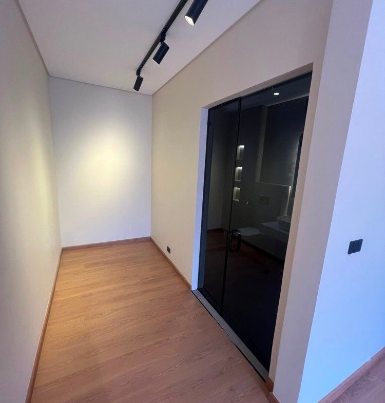 Room with a wood floor and a black door - apartment in SODIC Eastown, New Cairo