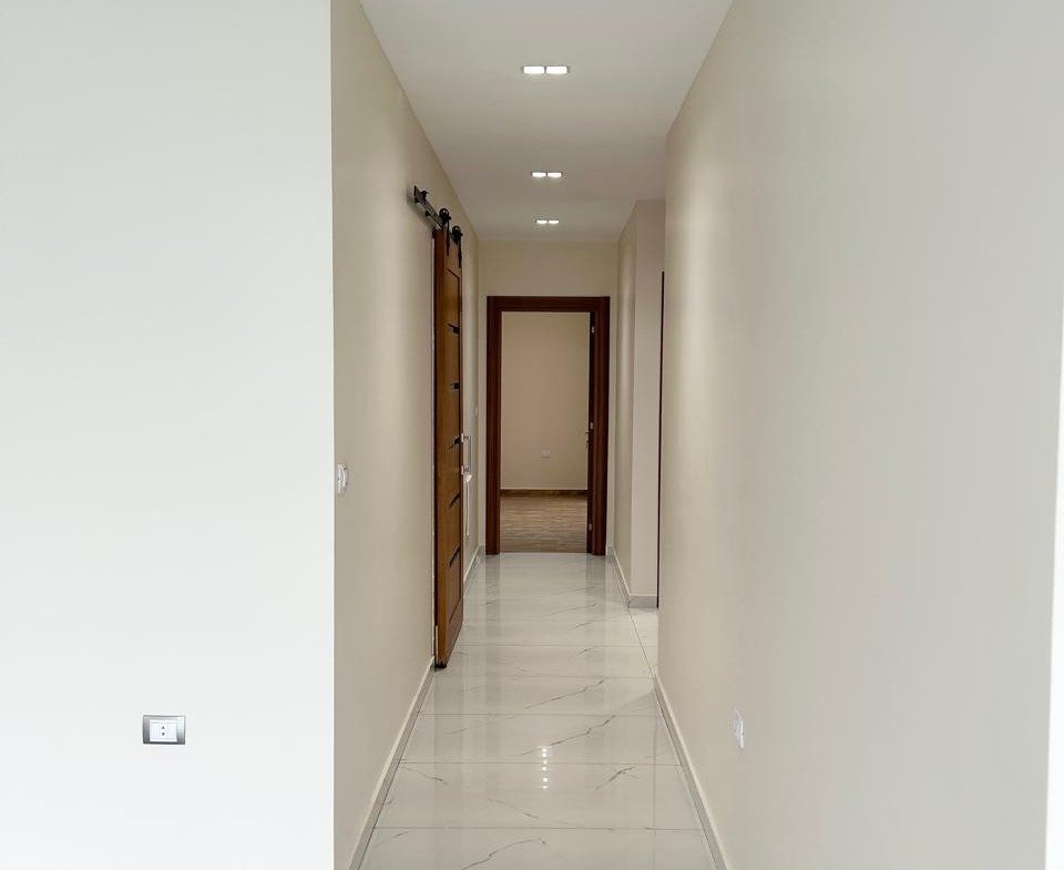 Hallway with marble floor and wooden door, Lake View Residence apartment