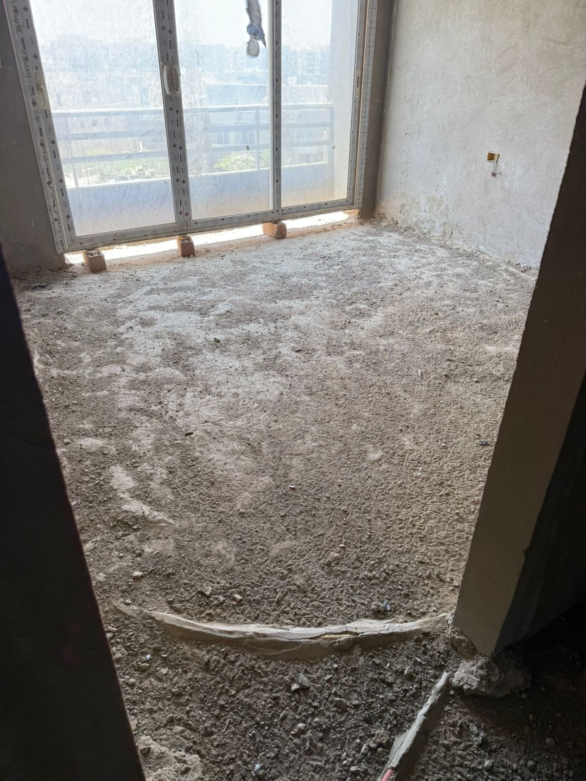 Unfinished living room with large window - apartment in Fifth Square, New Cairo