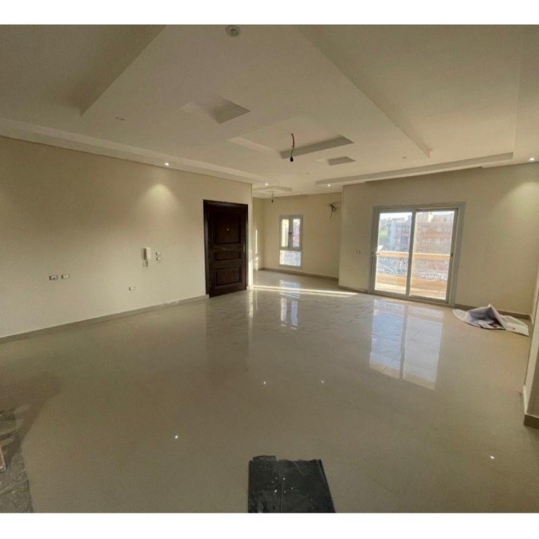 Large reception with a glossy floor and a ceiling fan - apartment in Al Banafseg 6, New Cairo