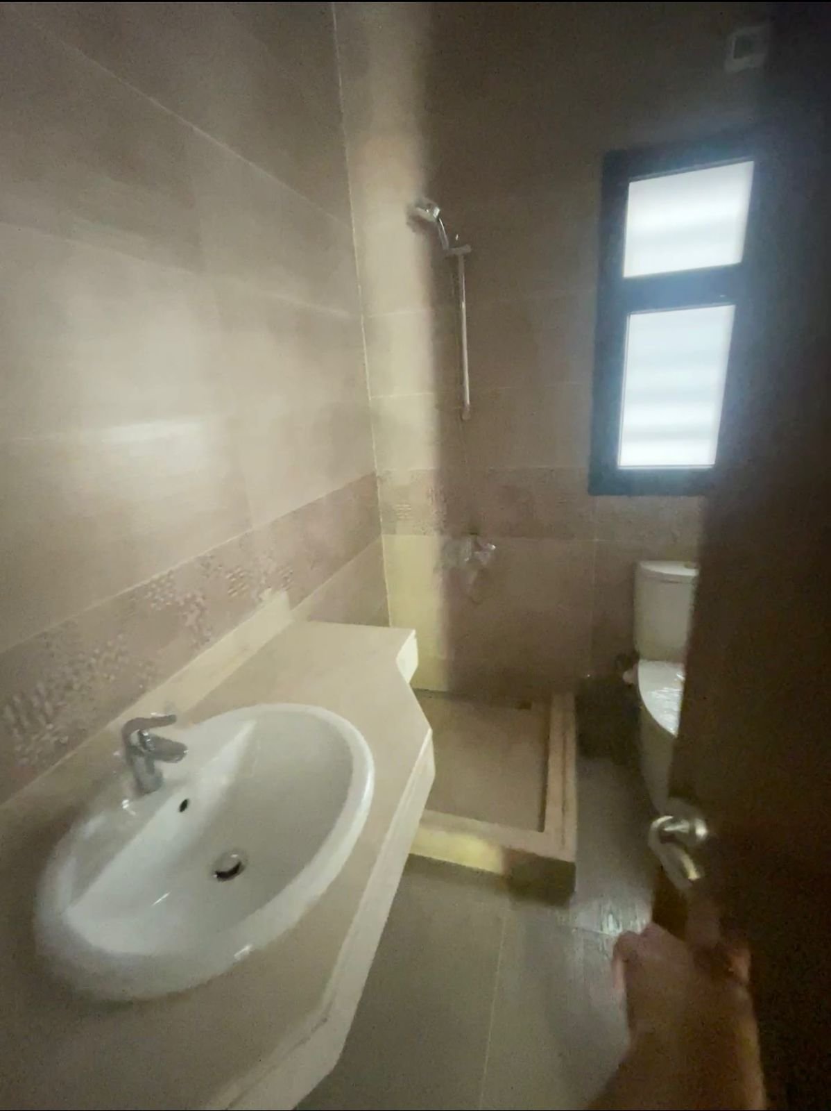 Bathroom with a white basin and a small shower window - apartment in Privado, New Cairo