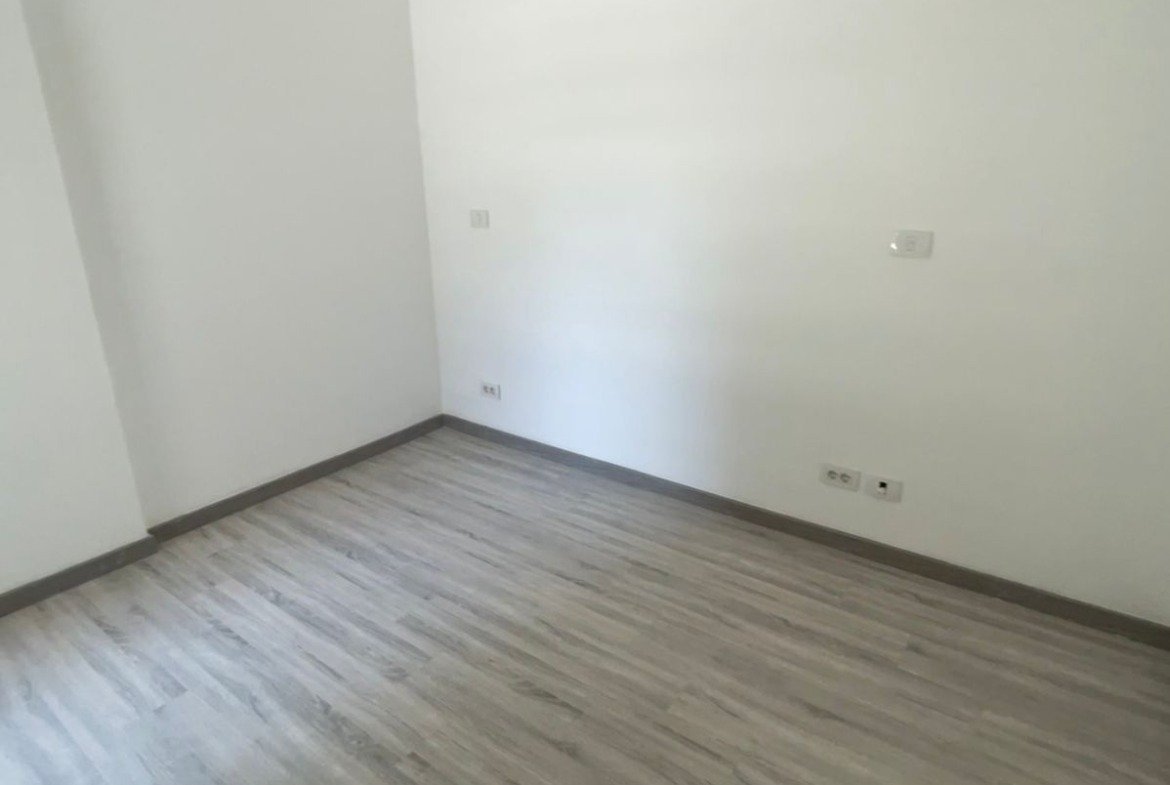 Empty room with white walls and a grey laminate floor - apartment in Privado, New Cairo